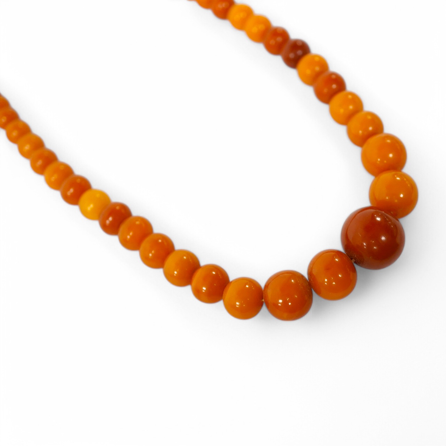 An amber bead necklace, composed of graduated amber beads measuring approximately 15.7-3.6mm, length 58cm, gross weight 23 grams. Condition: overall good, some minor crazing, some minor wear, commensurate with age